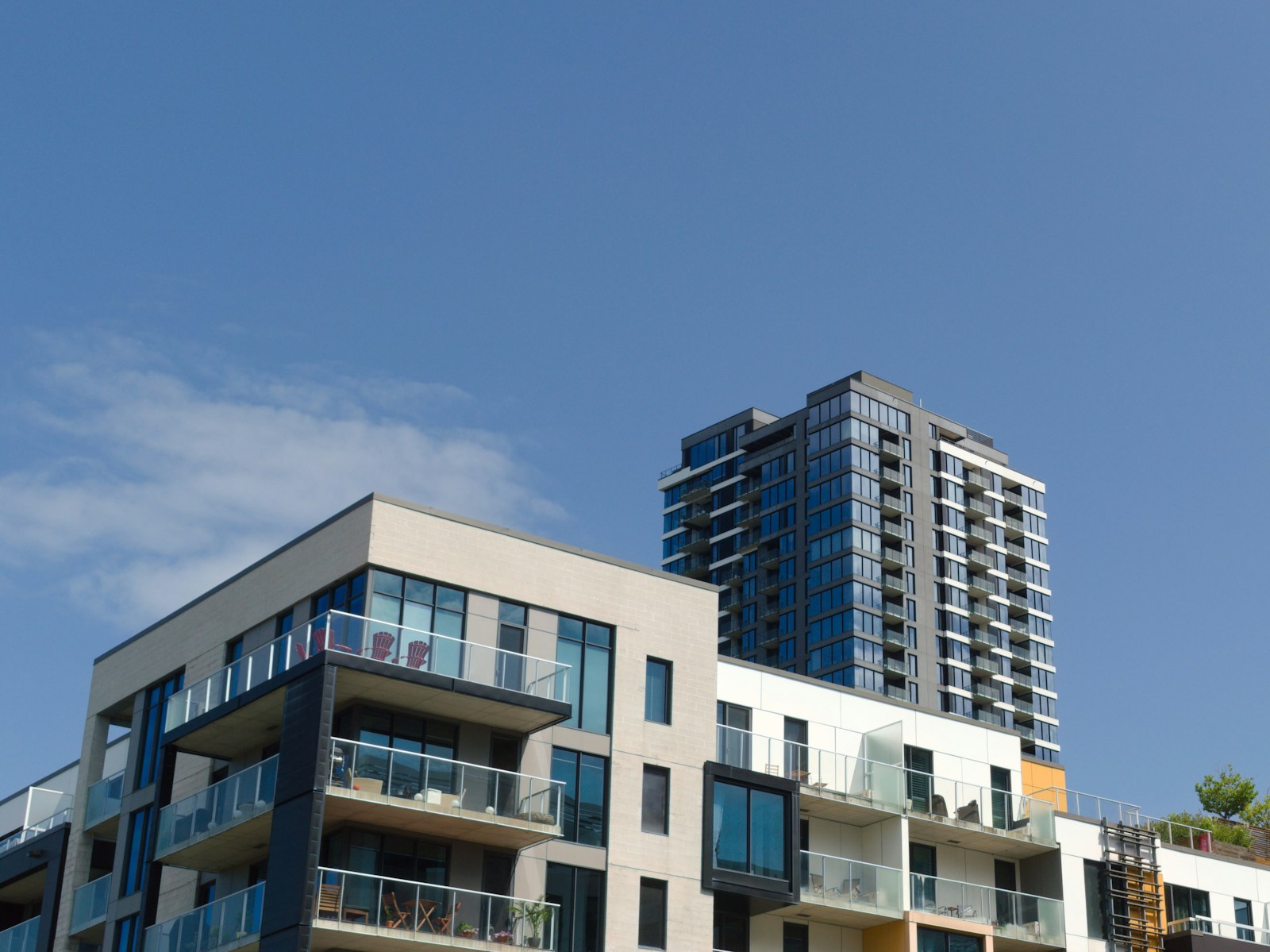 a couple of tall buildings sitting next to each other, condo